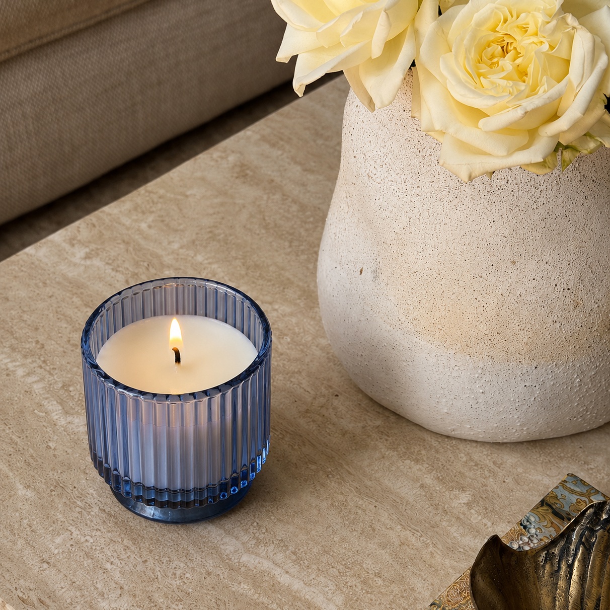 Your customer did not come in looking for a candle. They came in looking for a feeling.

And then they saw this sitting on a travertine surface next to white roses and a brass dish, burning quietly like it had been there all morning, and they stopped.

Not because it was loud. Because it was exactly right.
Our Ink Blue Ribbed Glass Candle Vessel is that vessel.

The vertical ribbing catches ambient light and scatters it in fine lines across the surface around it, turning every flat table into a quiet light show that only appears when you are close enough to notice. The deep ink blue glass deepens at the base where the ribs thicken into a weighted plinth, giving the vessel a sense of grounded permanence that most candle jars simply do not have.

And when the flame takes hold inside it, the white wax glows through the blue glass with the kind of warmth that makes a room feel like it exhaled.

This is the vessel your wholesale buyers do not negotiate on. They add it to the order and move on because the product justifies itself before the conversation about pricing even begins.

That is the position every hero SKU in a premium candle range needs to occupy. Not the one that needs explaining. The one that needs no explanation at all.
If your current range does not have that vessel yet, it does now.

Crafting Premium. Exporting Worldwide.

#RibbedGlassCandles #InkBlueCandle #WholesaleCandleVessels #PrivateLabelCandleSupplier #GlobalCandleExporter