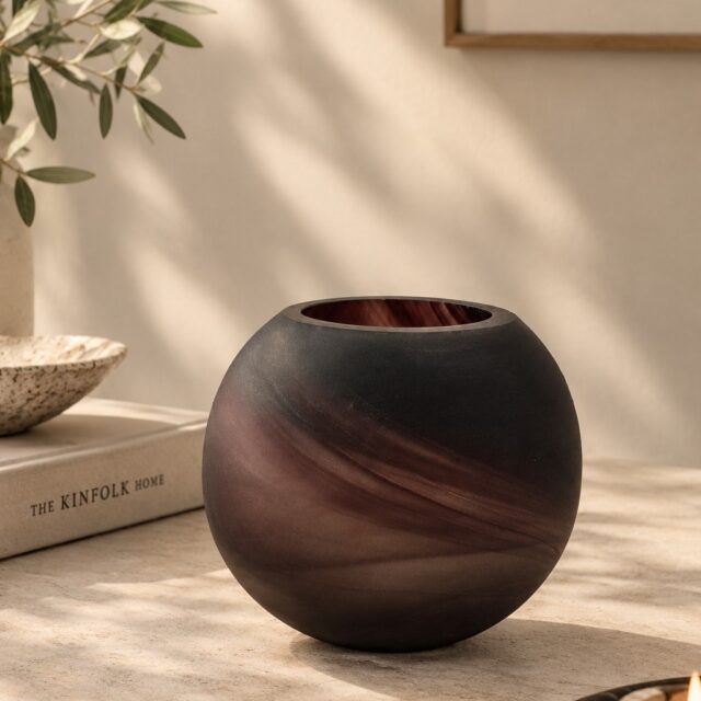 A play of colour, transparency and movement captured in glass. ✨ 

This round glass vessel features a deep smoky finish with flowing burgundy and plum-toned swirls that create a naturally layered look across its curved silhouette. The subtle variations, soft reflections and translucent depth give the piece a distinctive character, making it a beautiful choice for candle vessels, decorative accents or statement tabletop collections.

At Alchemy Art Studio, we manufacture and export glass, metal, ceramic and other home décor products for international brands, retailers and private-label businesses. Our focus is on combining distinctive design with reliable manufacturing—paying attention to glass quality, clarity, finish, consistency, smooth edges and detailed surface treatments across production. From custom colours and patterns to unique shapes and decorative finishes, we help brands develop home décor pieces that fit their collection while maintaining a refined and consistent appearance.